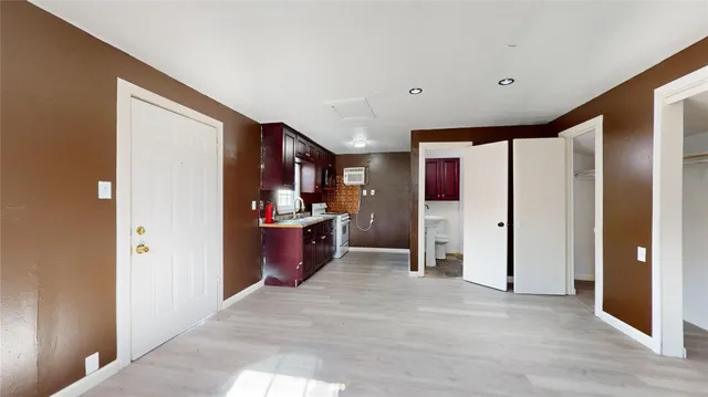 a view of a hallway with wooden shelves