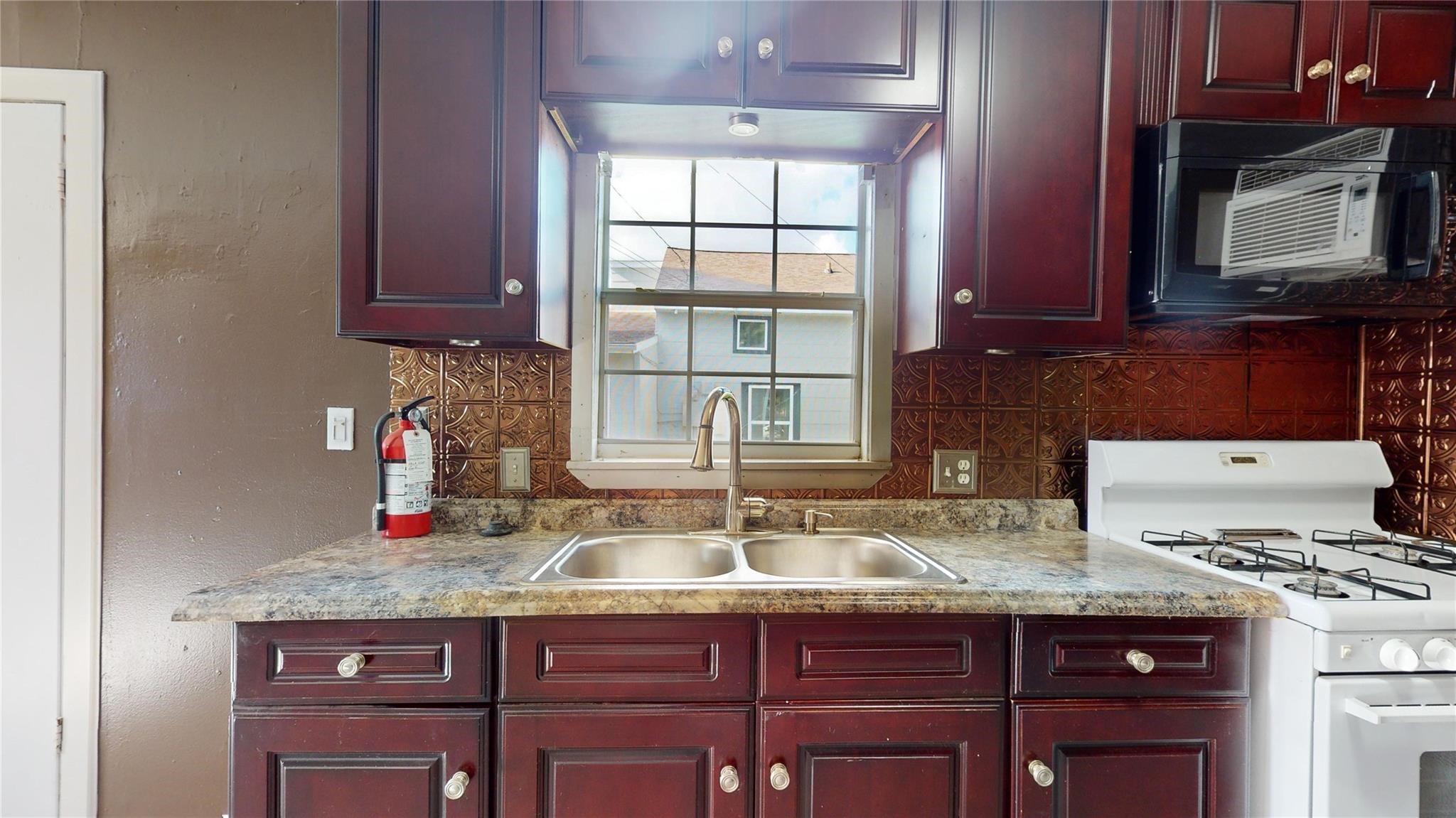 3806 Cosby Street Houston, TX 77021 - Photo 44 of 48 a kitchen with granite countertop a sink stove and cabinets
