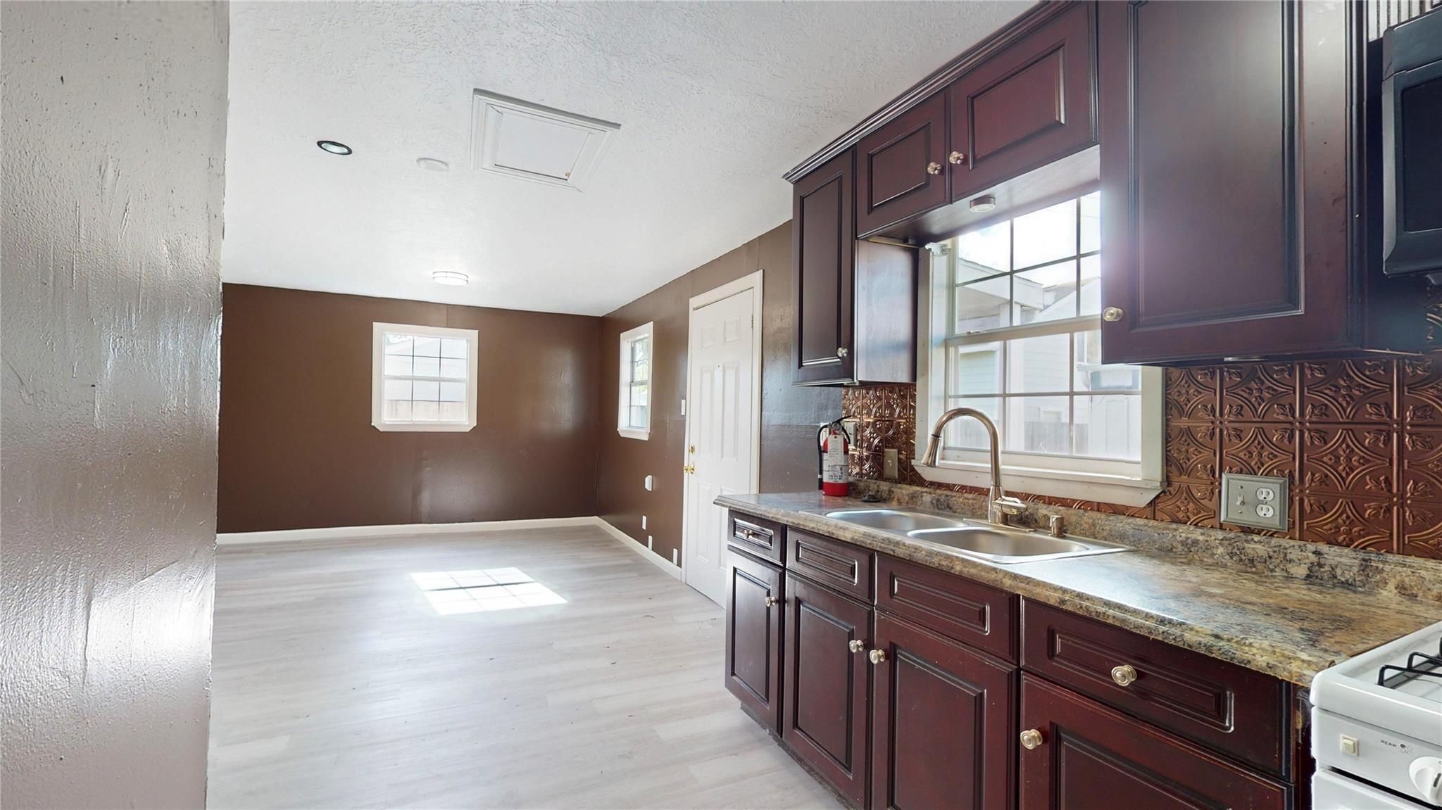 3806 Cosby Street Houston, TX 77021 - Photo 46 of 48 a kitchen with granite countertop a sink stainless steel appliances and cabinets