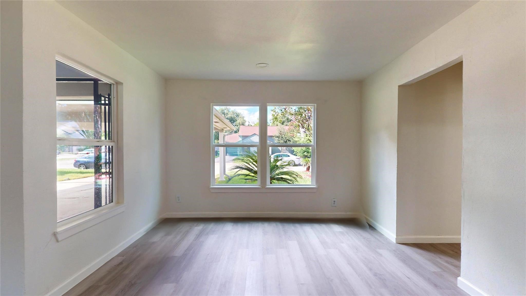 3806 Cosby Street Houston, TX 77021 - Photo 9 of 48 a view of an empty room with wooden floor and a window