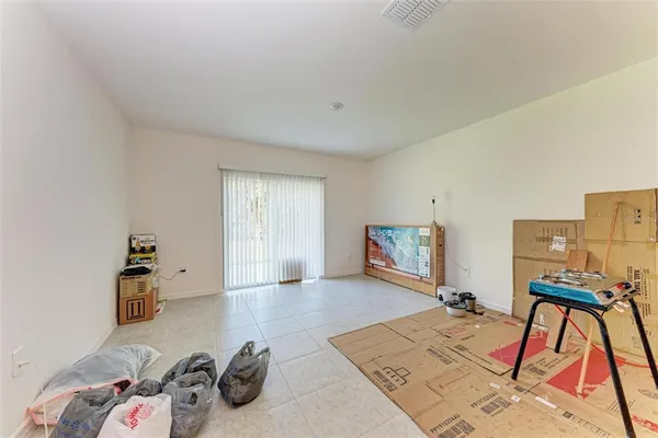 a living room with a fireplace furniture and a large window