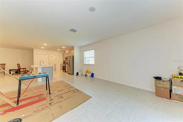 a kitchen with stainless steel appliances a refrigerator sink stove and white cabinets