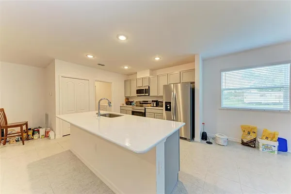 a kitchen with refrigerator a stove and wooden cabinets