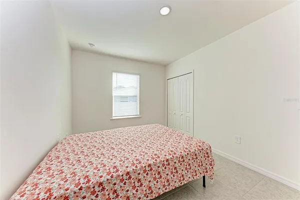 a bedroom with a bed and a curtain