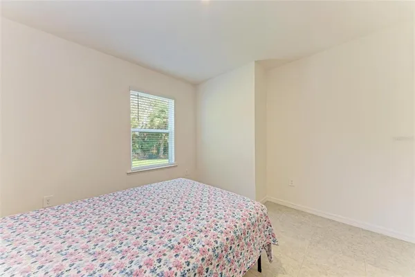 a bedroom with a bed and a table