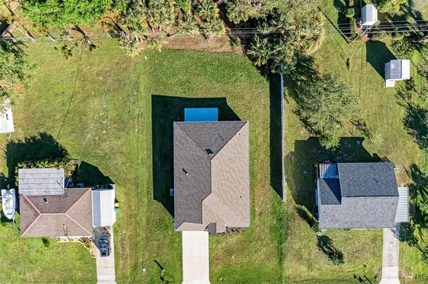 an aerial view of a house with a swimming pool outdoor seating