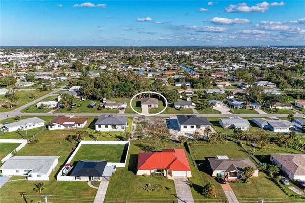 an aerial view of a houses with a yard