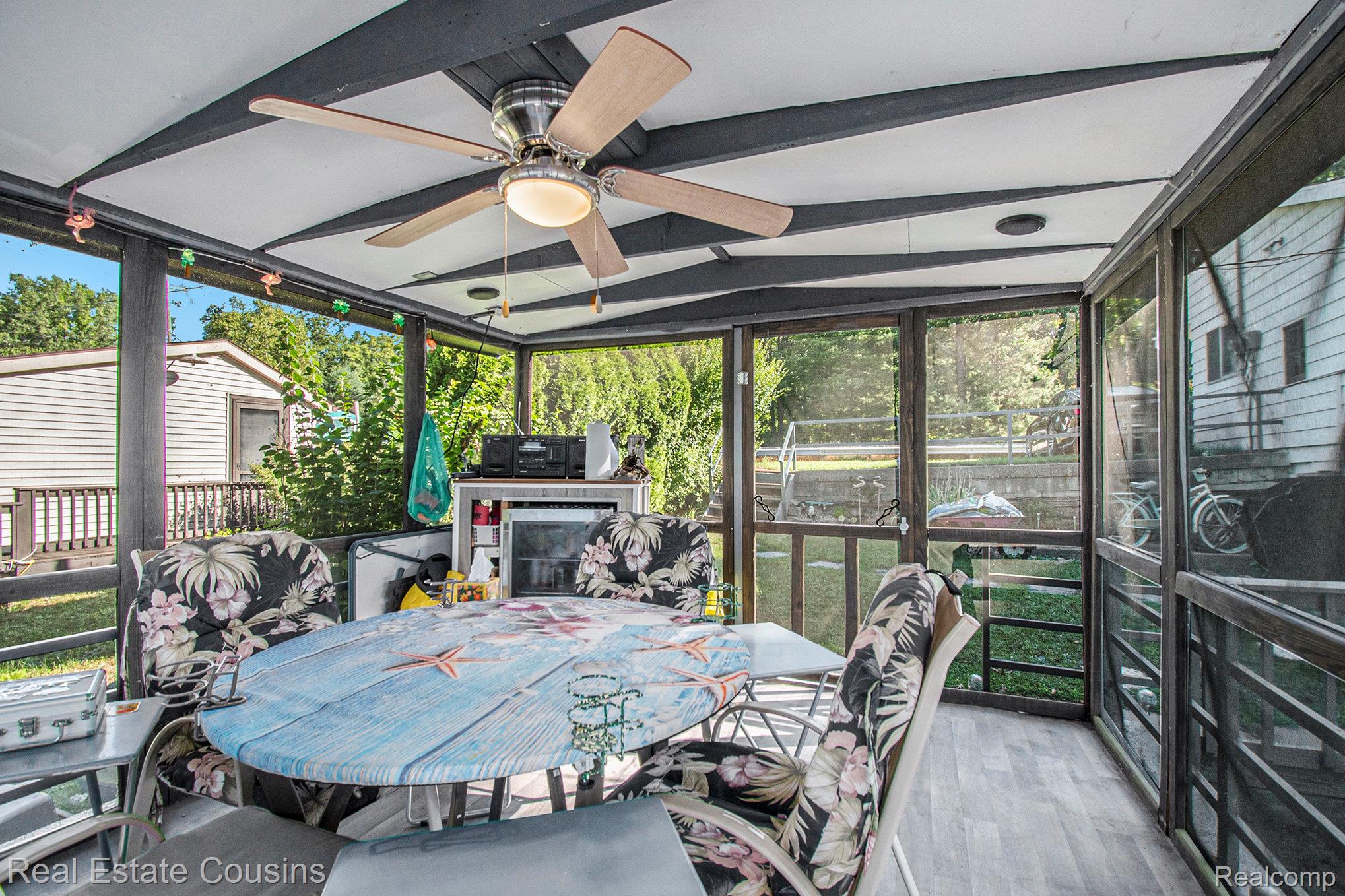 1734 Forest Road Harrison, MI 48625 - Photo 21 of 31 Sunroom / solarium with outdoor dining area, healthy amount of natural light, lofted ceiling, and ceiling fan