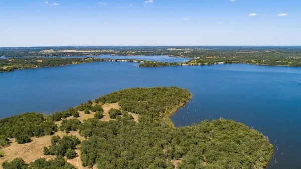 an aerial view of a houses with a lake view