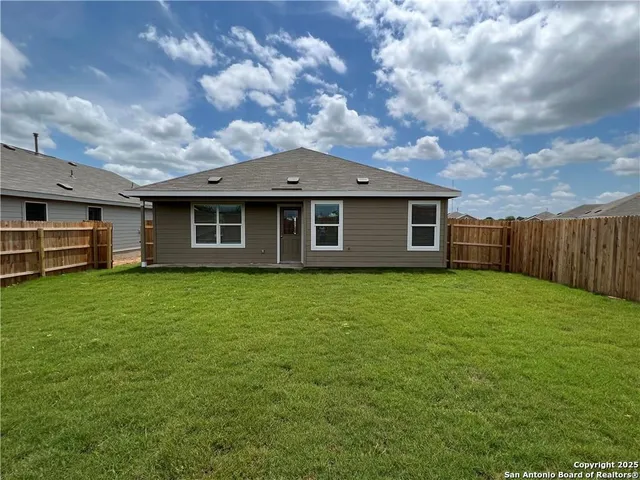 a view of a house with a backyard