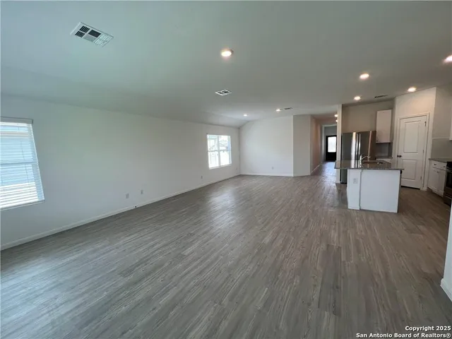 a view of a kitchen with a sink and wooden floor