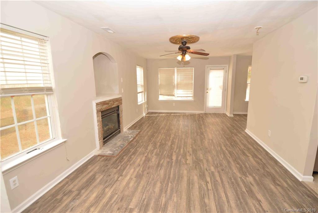 4918 Elizabeth Road Charlotte, NC 28269 - Photo 3 of 18 wooden floor in an empty room with a window