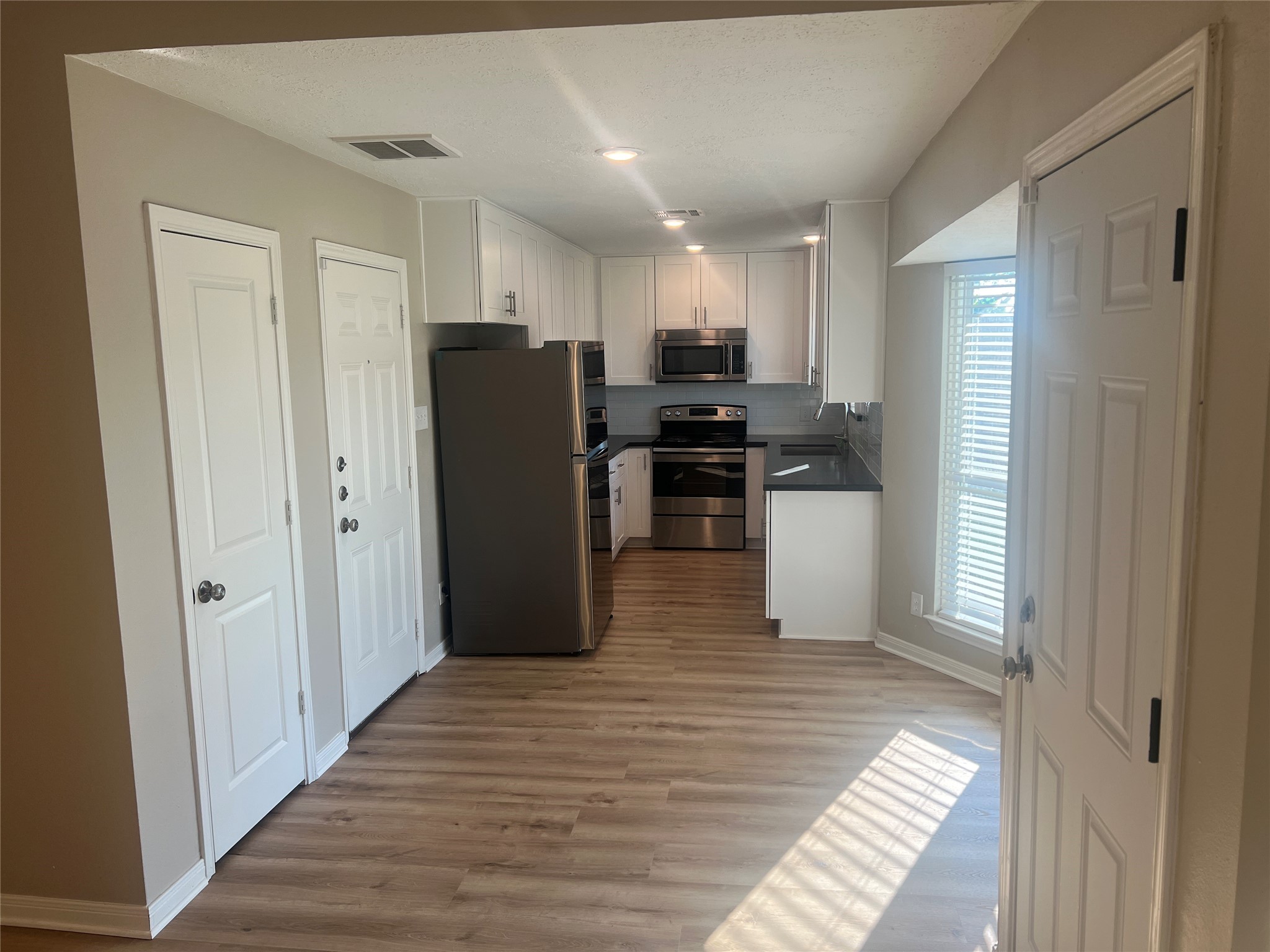 10507 Kirkdale Drive Houston, TX 77089 - Photo 5 of 7 a kitchen with stainless steel appliances refrigerator and cabinets