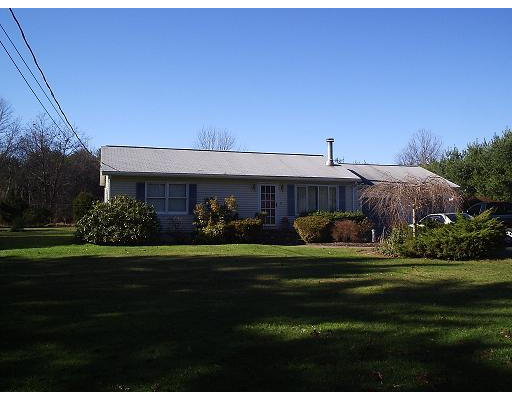 247 Perry Hill Road Acushnet, MA 02743 - Photo 1 of 6 a front view of a house with a yard table and chairs