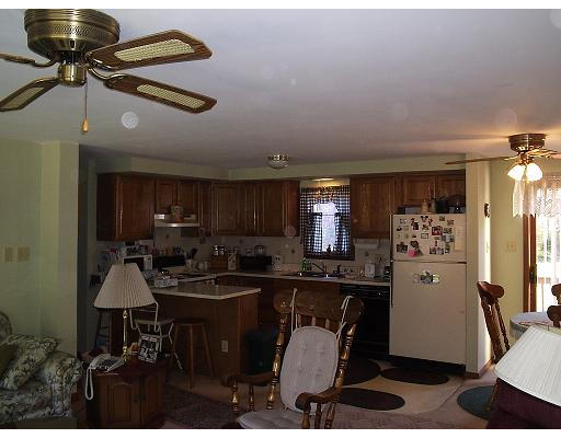 247 Perry Hill Road Acushnet, MA 02743 - Photo 5 of 6 a kitchen with kitchen island granite countertop a sink cabinets and stainless steel appliances