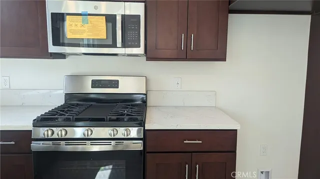 a kitchen with stove and cabinets