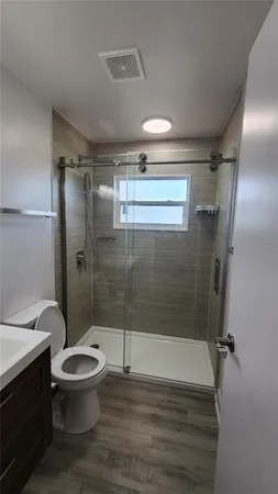 a bathroom with a toilet and a shower