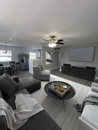 a living room with furniture and a chandelier