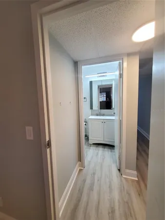 a view of an empty room with a fireplace and a window