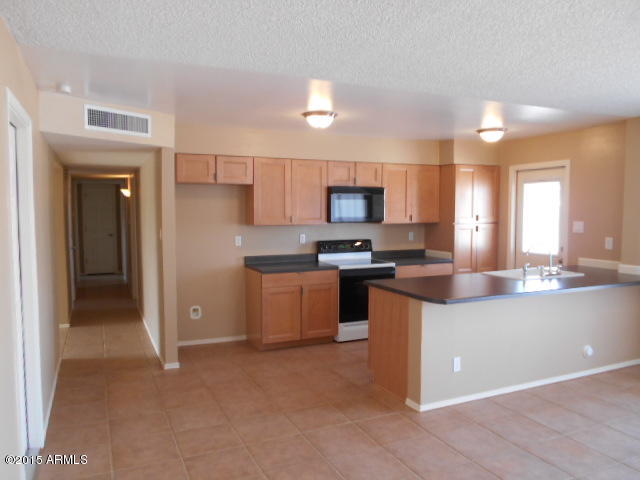 4 East Del Rio Drive Tempe, AZ 85282 - Photo 4 of 22 a kitchen with stainless steel appliances a sink a stove a refrigerator cabinets and a window