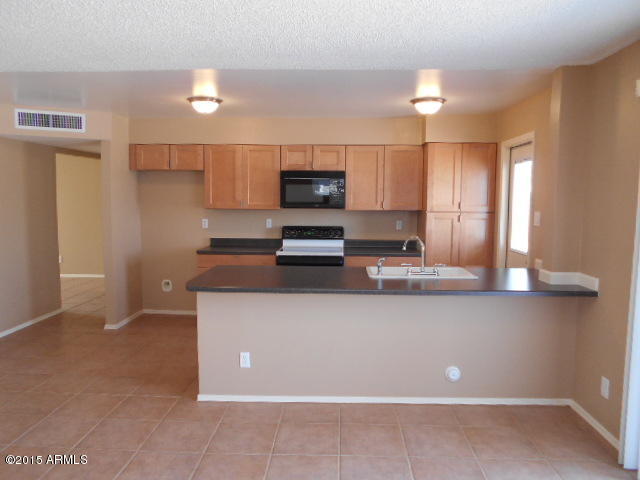 4 East Del Rio Drive Tempe, AZ 85282 - Photo 5 of 22 a kitchen with stainless steel appliances granite countertop a stove a sink and a refrigerator