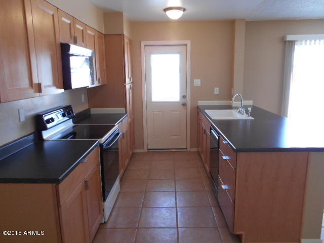 4 East Del Rio Drive Tempe, AZ 85282 - Photo 6 of 22 a kitchen with a sink stove top oven and cabinets
