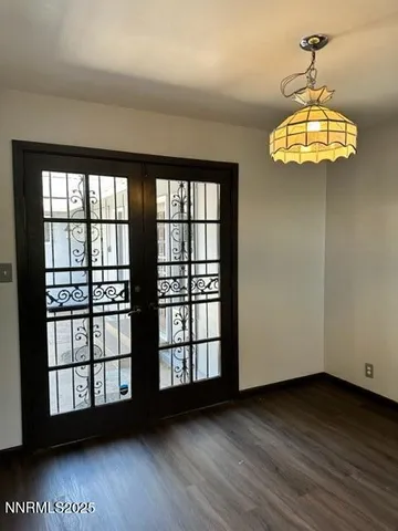 a view of a room with wooden floor and chandelier