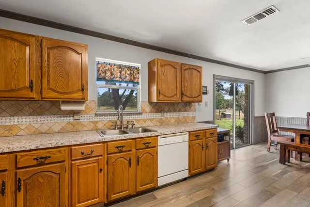 a kitchen with stainless steel appliances granite countertop a sink and cabinets