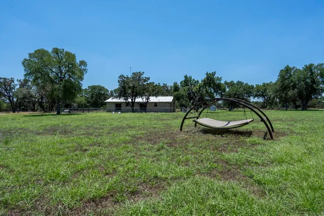 a backyard of a house with table and chairs