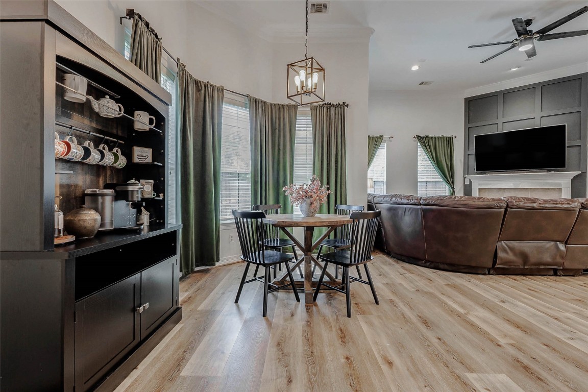 4403 Wickby Street Fulshear, TX 77441 - Photo 17 of 50 Adjoined to the kitchen is a bright & spacious breakfast area providing plenty of light with a modern light fixture adding some cozy charm. Notice the stunning fireplace in the living room.