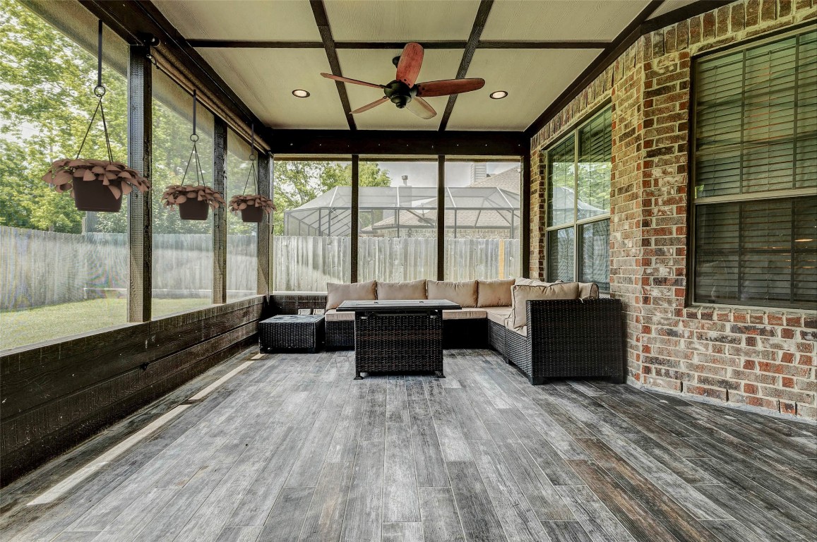 4403 Wickby Street Fulshear, TX 77441 - Photo 39 of 50 Step outside and be captivated by the spacious, relaxing screened-in porch and wood tile floors. With ample room to unwind, this serene outdoor space seamlessly extends your living area, offering the perfect spot to enjoy the outdoors in comfort.