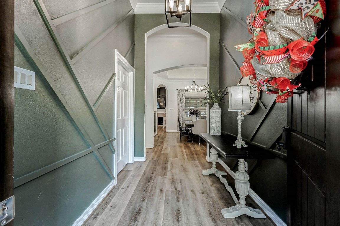 4403 Wickby Street Fulshear, TX 77441 - Photo 6 of 50 Step inside the grand foyer showcasing an arched doorway that leads to a well-lit dining room. The door to the left is one of the 5 bedrooms that this home offers.