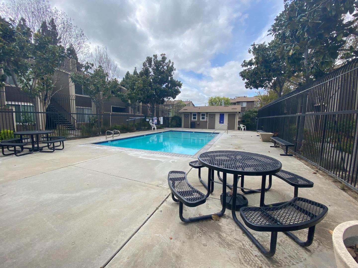2664 Senter Road, Unit 223 San Jose, CA 95111 - Photo 11 of 11 a backyard of a house with fire pit table and chairs