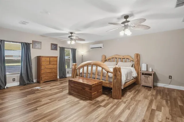 a bedroom with a bed and a chandelier