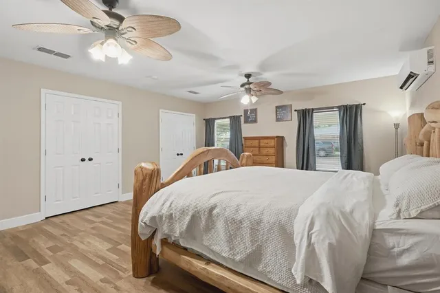 a bed room with a bed mirror and a chandelier