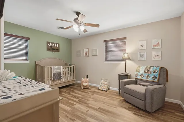 a living room with a bed furniture and a window