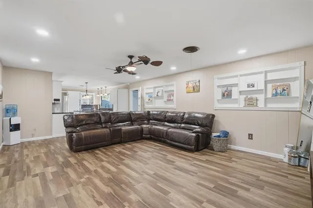 a living room with furniture and wooden floor