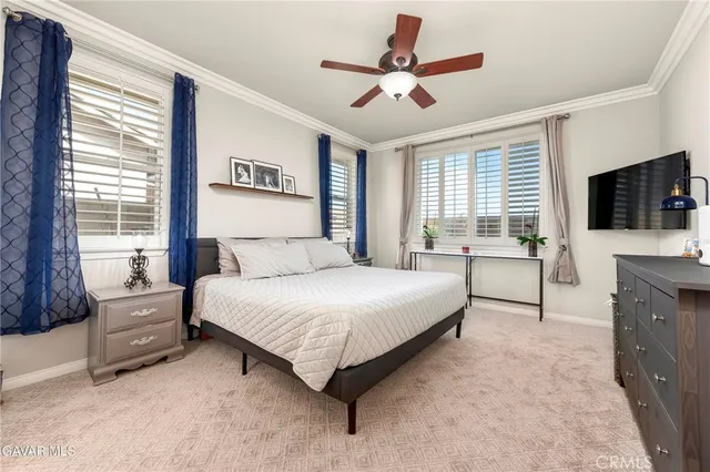 a spacious bedroom with a large bed and a flat screen tv