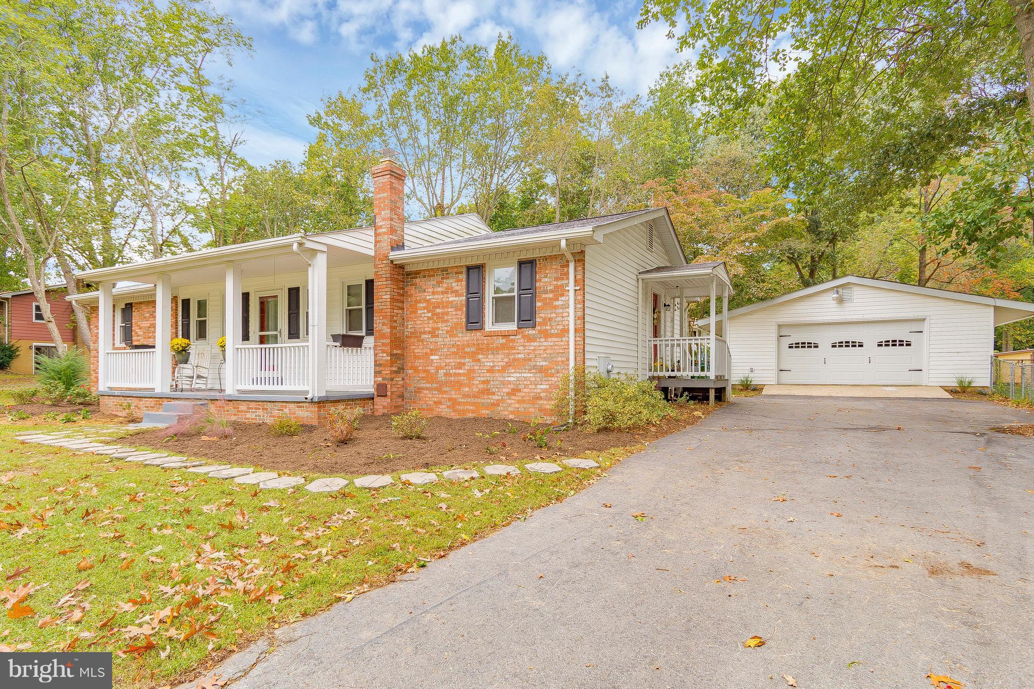 1218 Calvert Beach Road St. Leonard, MD 20685 - Photo 1 of 29 a front view of a house with a yard and trees