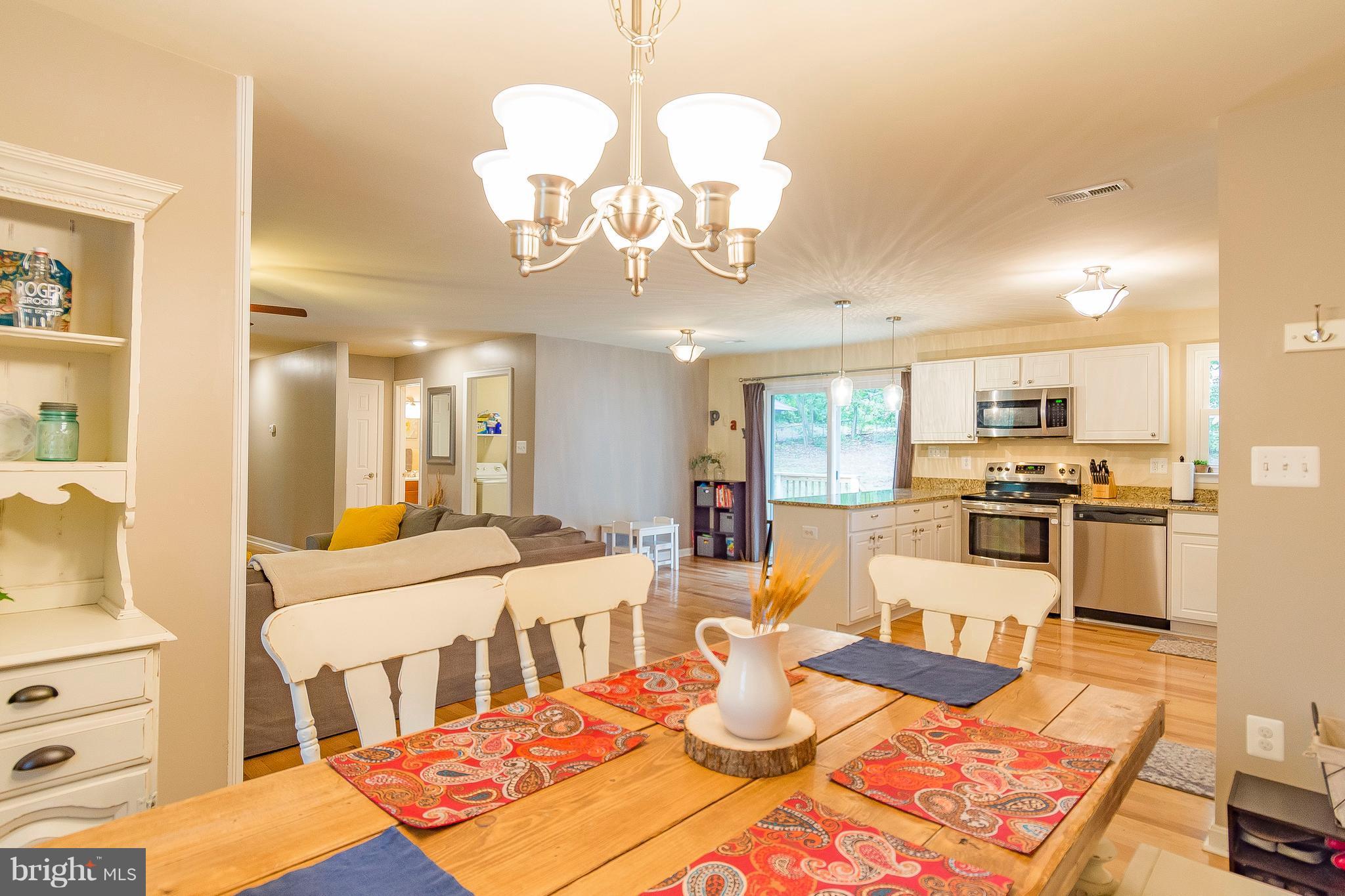 1218 Calvert Beach Road St. Leonard, MD 20685 - Photo 11 of 29 a large kitchen with a table and chairs