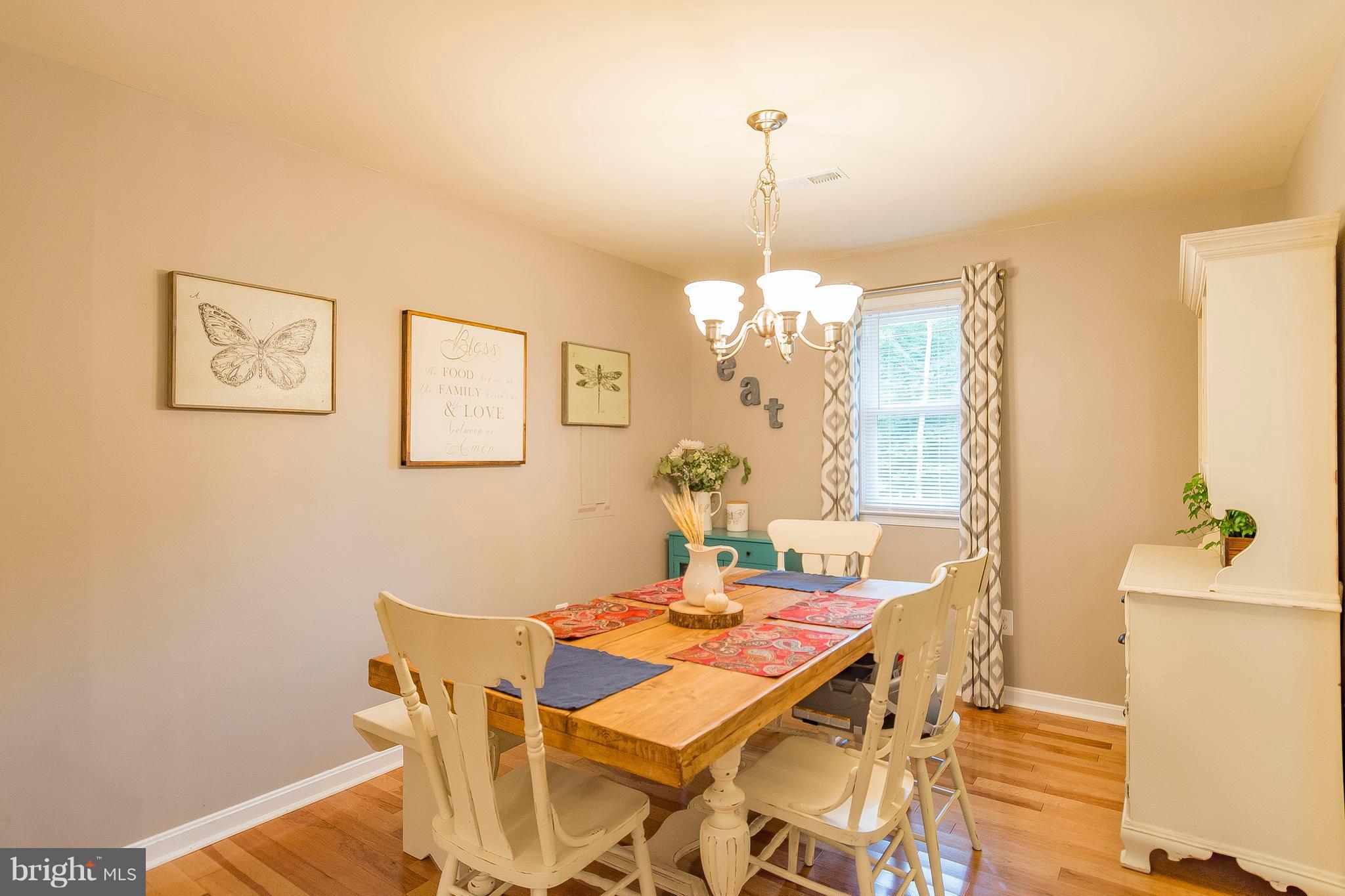 1218 Calvert Beach Road St. Leonard, MD 20685 - Photo 12 of 29 a view of a dining room with furniture and wooden floor