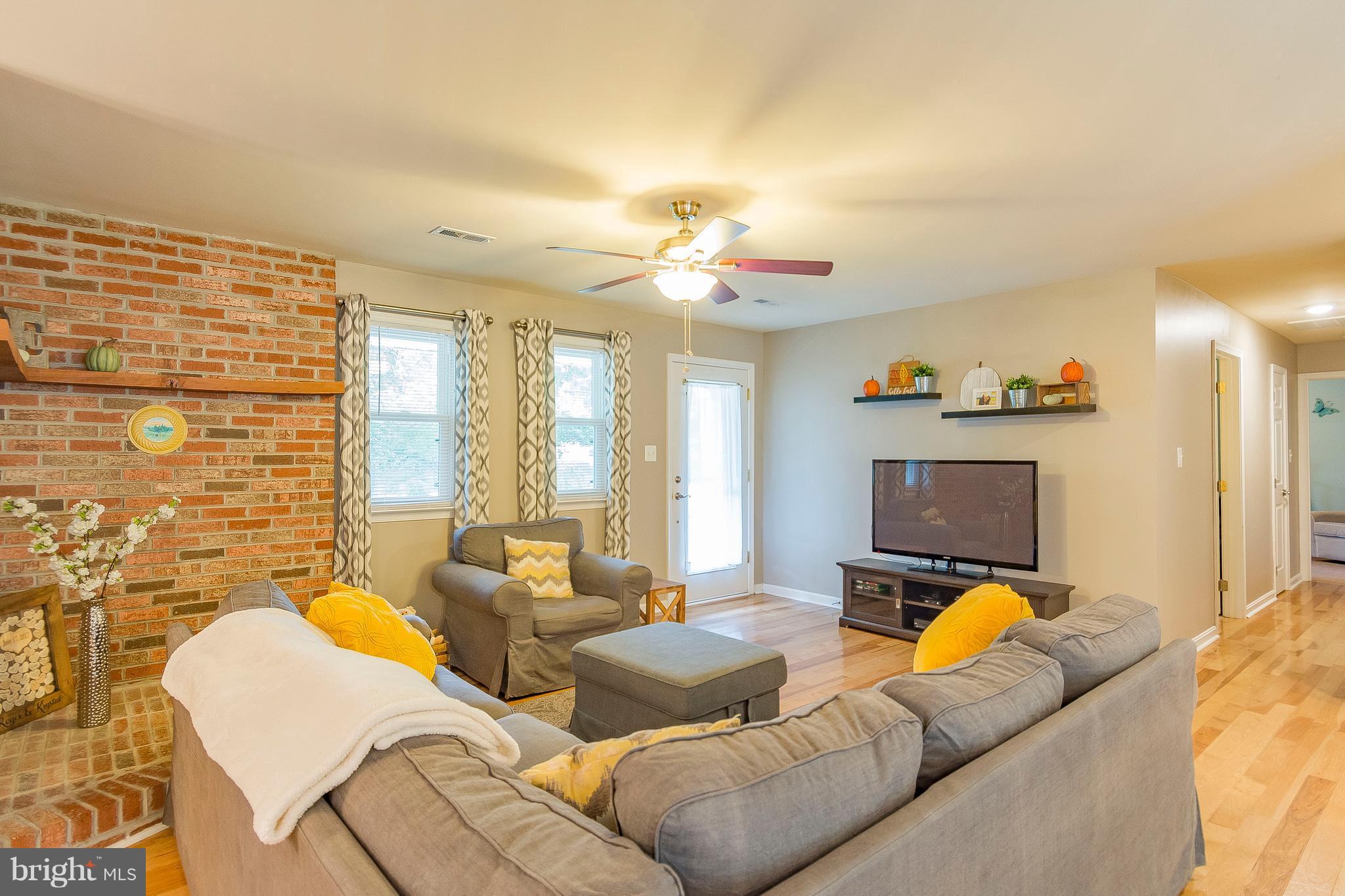 1218 Calvert Beach Road St. Leonard, MD 20685 - Photo 13 of 29 a living room with furniture and a flat screen tv