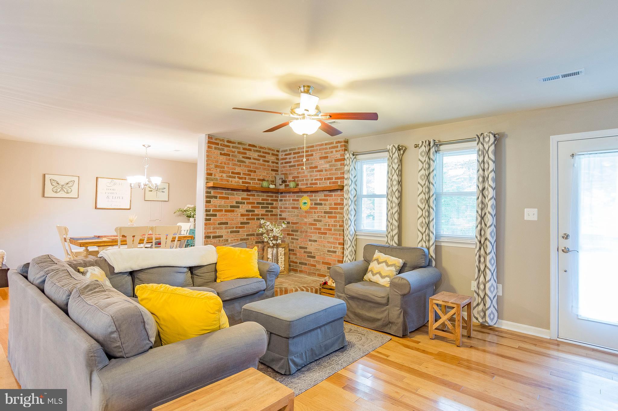1218 Calvert Beach Road St. Leonard, MD 20685 - Photo 14 of 29 a living room with furniture and a chandelier