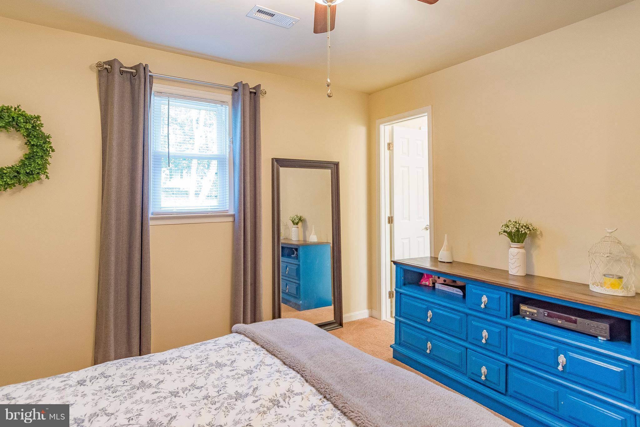 1218 Calvert Beach Road St. Leonard, MD 20685 - Photo 20 of 29 a bedroom with a bed and a dresser in it