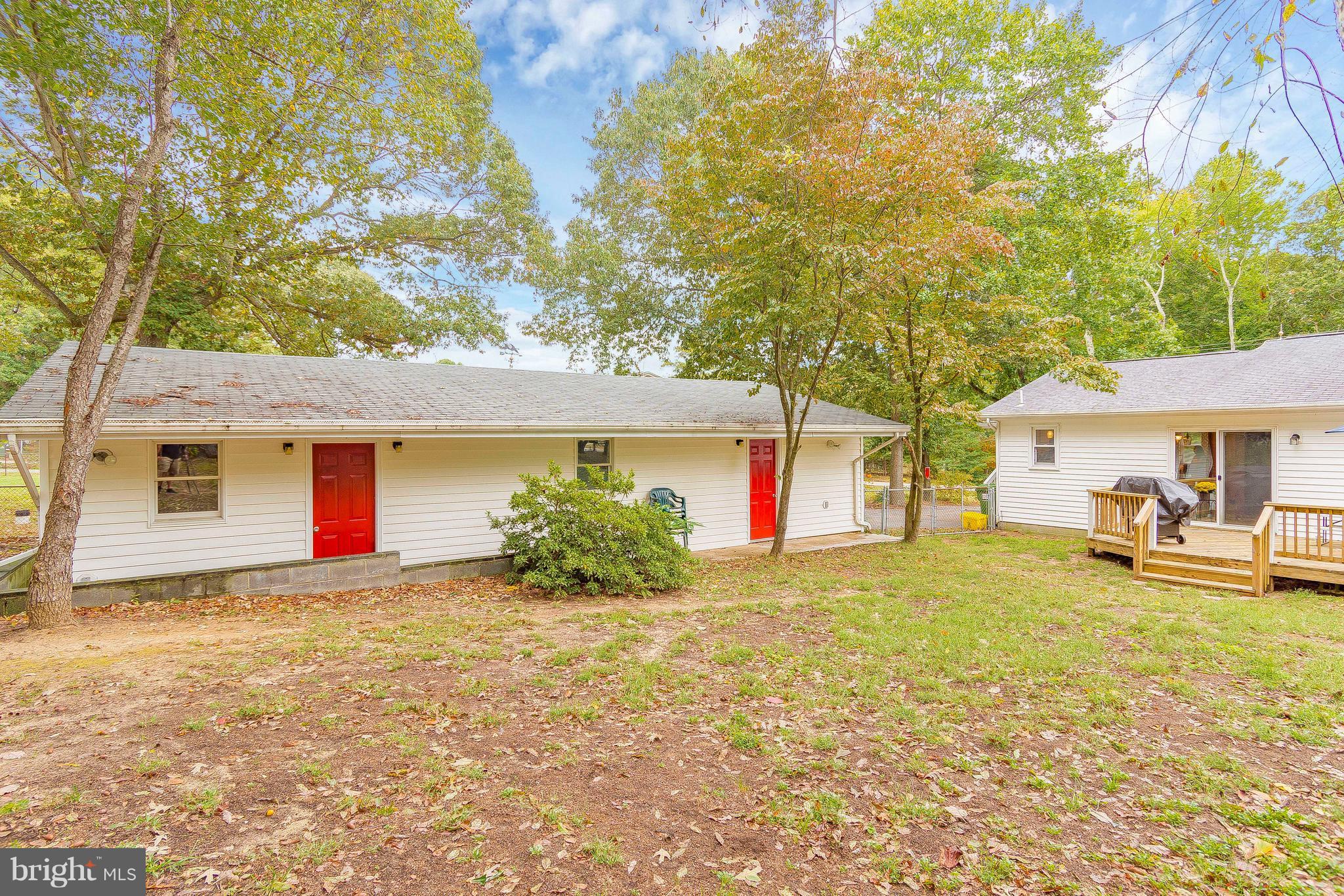 1218 Calvert Beach Road St. Leonard, MD 20685 - Photo 25 of 29 a view of a house with a yard and garage
