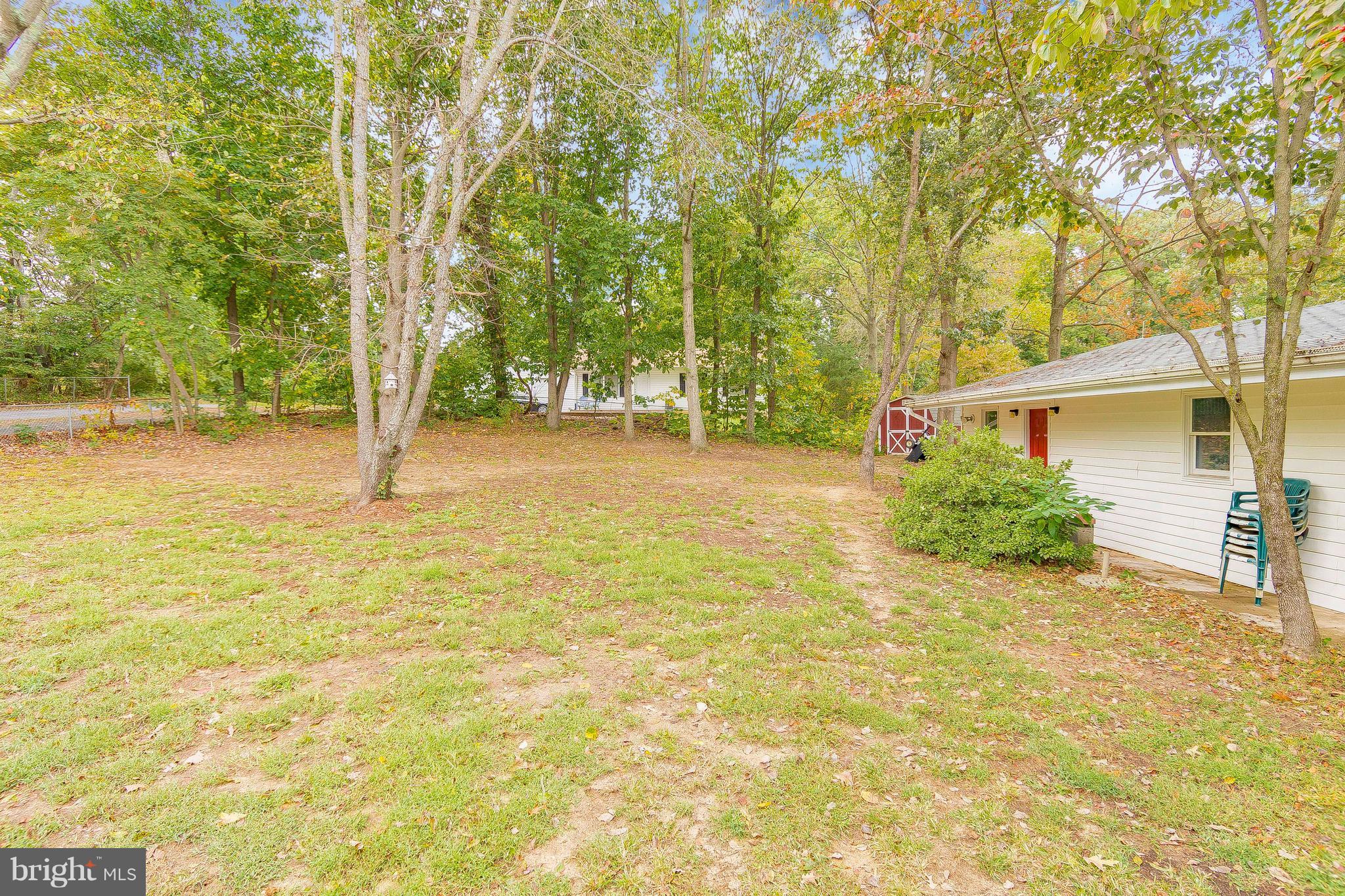 1218 Calvert Beach Road St. Leonard, MD 20685 - Photo 27 of 29 a backyard of a house with table and chairs