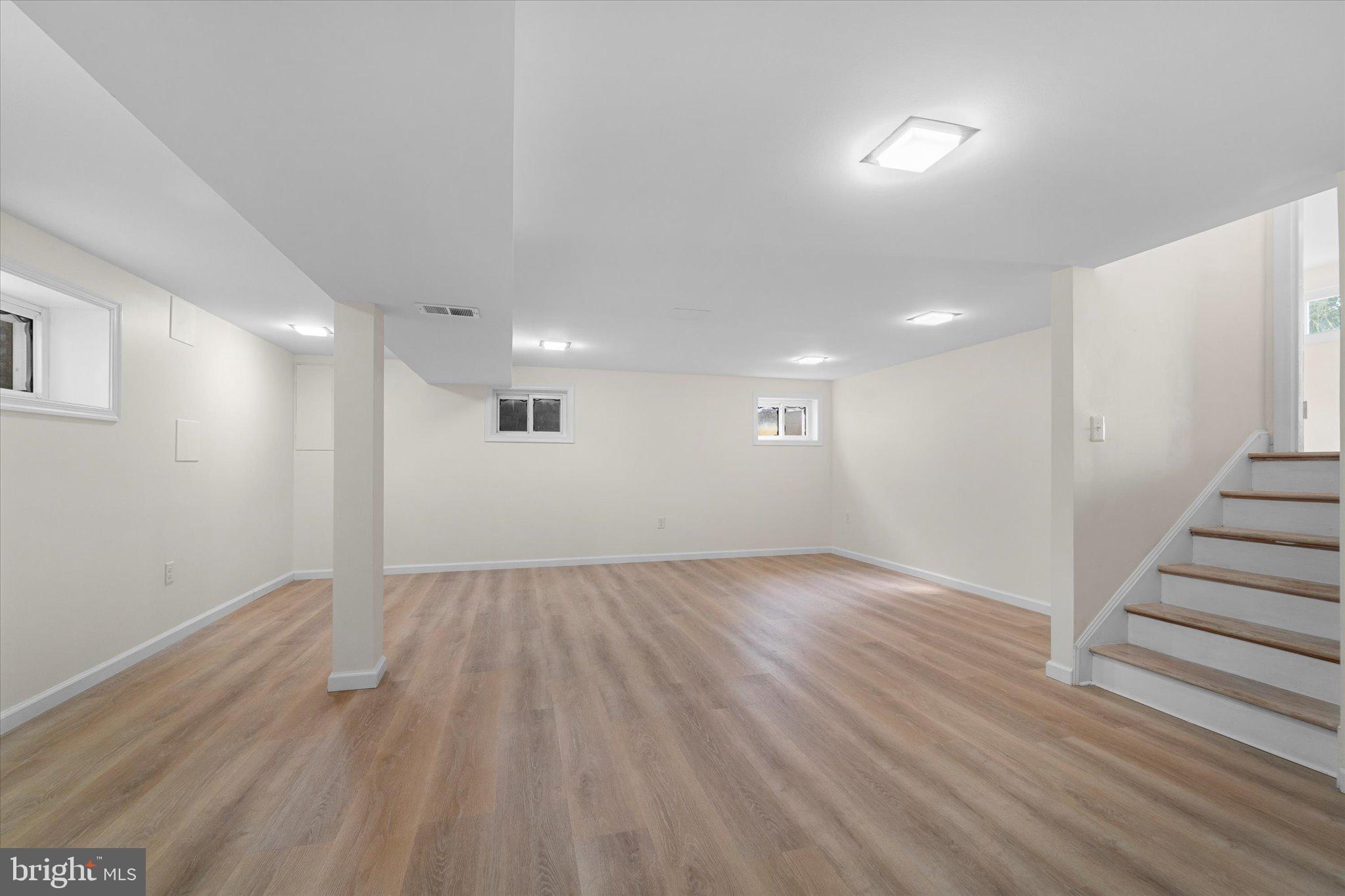 9012 Vernon View Drive Alexandria, VA 22308 - Photo 31 of 39 an empty room with wooden floor and windows