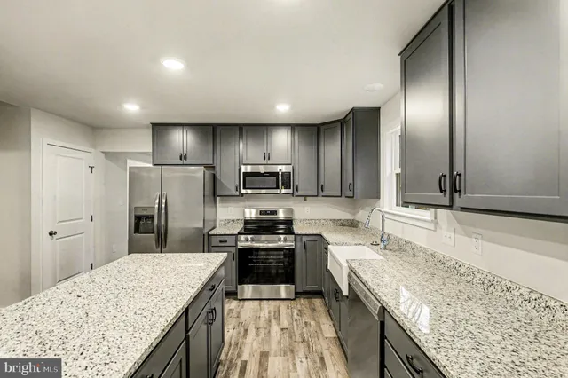 a kitchen with granite countertop cabinets sink and window