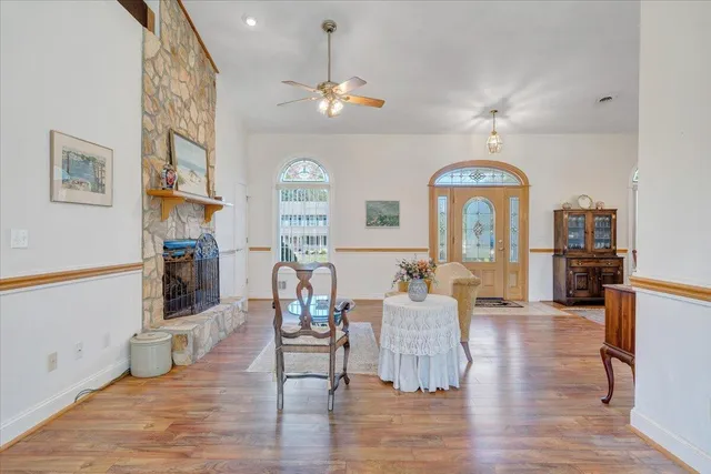 a living room with furniture a fireplace and a chandelier