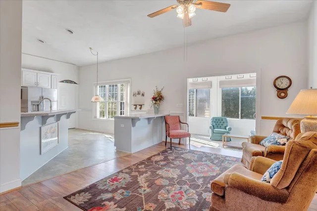 a living room with furniture and a chandelier